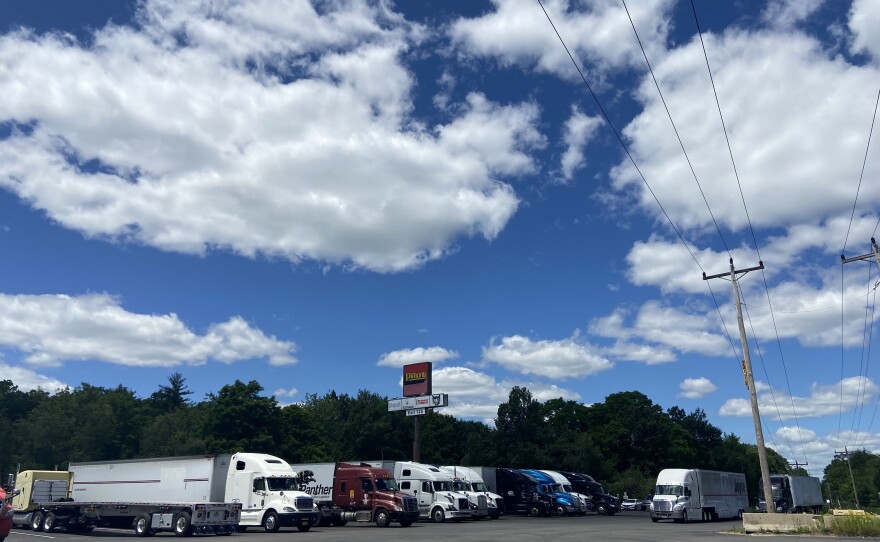 trucks in a prking lot with nice clouds