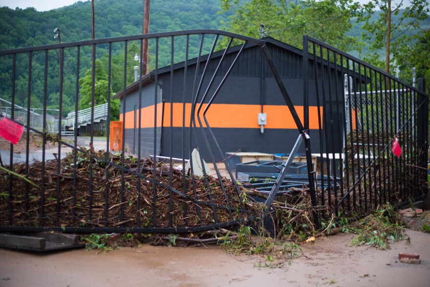 Debris from historic heavy rains in Richwood, WV, bent a metal gate outside of the town's middle school.