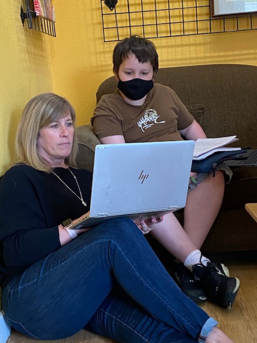 Suellen Krahn meets with student David Schapiro. Christina, David's mother, attributes the kids' success in the virtual program in large part to Krahn.