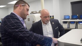  Reditus CEO Aaron Rossi leads a tour of its coronavirus testing lab with Pekin mayor Mark Luft. 