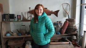 (Feb. 2, 2020): Kelsey Hayden poses for a photo at her workplace, Cordova District Fishermen United. Hayden is also part of the Iceworm Festival’s committee. She says numbers for the festival were down this year, thanks to bad weather and lack of ferry service. (Erin McKinstry/Alaska Public Media)
