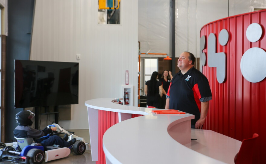 Travis Mitchell, marketing director for AWC's Entrepreneurial College, looks on as Gov. Hobbs enters the AWC Wellton Future48 Workforce Accelerator.