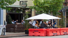 People gather for food and drinks in the Over-the-Rhine as restaurants and bars begin to reopen in the wake of the coronavirus pandemic, Saturday, May 16, 2020.