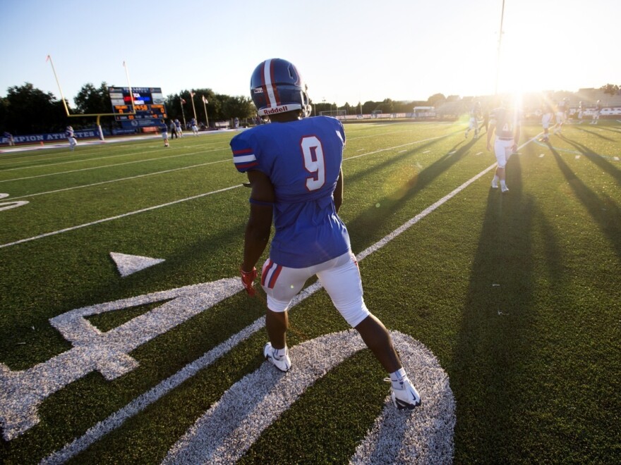 Nahshon Ellerbe, a star running back at Trinity Christian Academy in Addison, Texas, warms up before a game against Midland Christian.