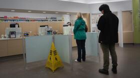 People wait in line at a Walgreens pharmacy in Roseville on Thursday, March 26, 2026.