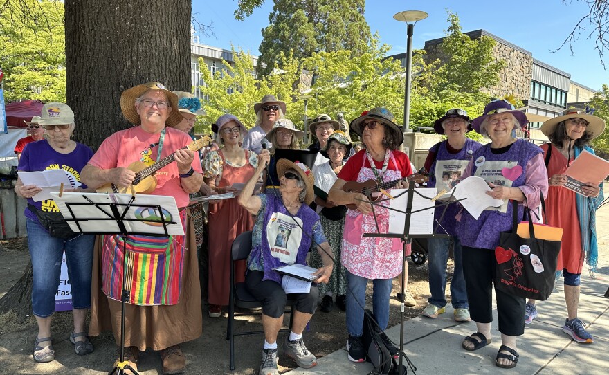 Women singing on corner.