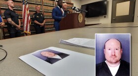 Jarrett Woodfork of the Onondaga County District Attorney's Office conducts a news conference with, at far left, Onondaga County Sheriff's Deputy Ryan Schruise and at right, Sheriff Toby Shelley concerning the arrest on child sex-related charges of Luke Underwood (mugshot in inset, provided by the District Attorney's office).