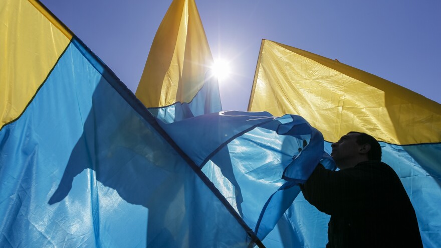 An activist waves the Ukrainian national flag at Independence Square on April 6.