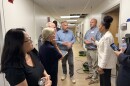 Eight people standing in a hallway