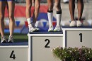 Second-place winners AB Hernandez, center right, and Brooke White share the podium during a medal ceremony for the long jump at the California high school track-and-field championships in Clovis, Calif., Saturday, May 31, 2025. (AP Photo/Jae C. Hong)
