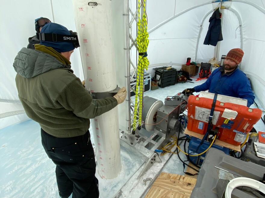 Graduate student Jenna Epifanio keeps the drill barrel straight while driller Tanner Kuhl lowers it into the hole in 2019. This Antarctica expedition focused on recovering large volume samples of the 2-plus-million-year-old ice discovered four years earlier.