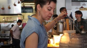 Dominica Rice serves drinks at her restaurant Cosecha as Rene Sanchez and Panfila Ceja work behind her and customers wait in line on March 9, 2017. Rice has already repaid her SBA loan. (Farida Jhabvala Romero/KQED)