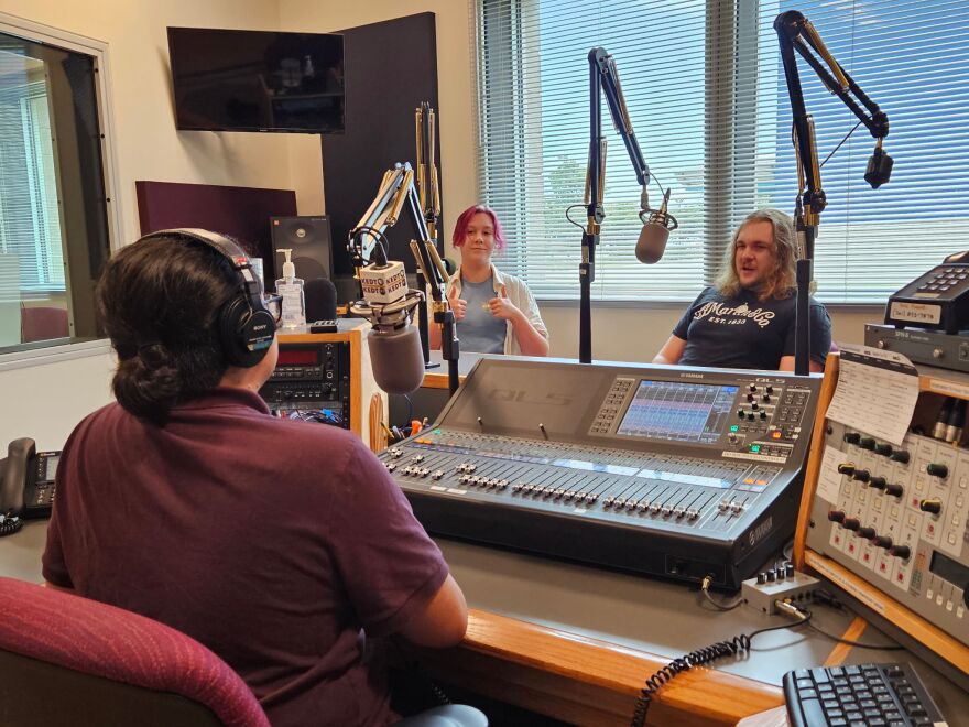 From left: KEDT's Gabriel Cando chats with Ginger Martin and her brother Devereaux, both in the local-based rock group The 99s, about the live music scene in Corpus Christi.