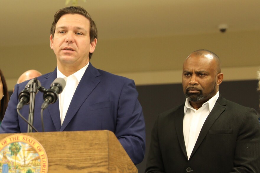 Ken Lawson, right, listens at a 2019 event with Gov. Ron DeSantis. (Courtesy of Governor's Press Office)