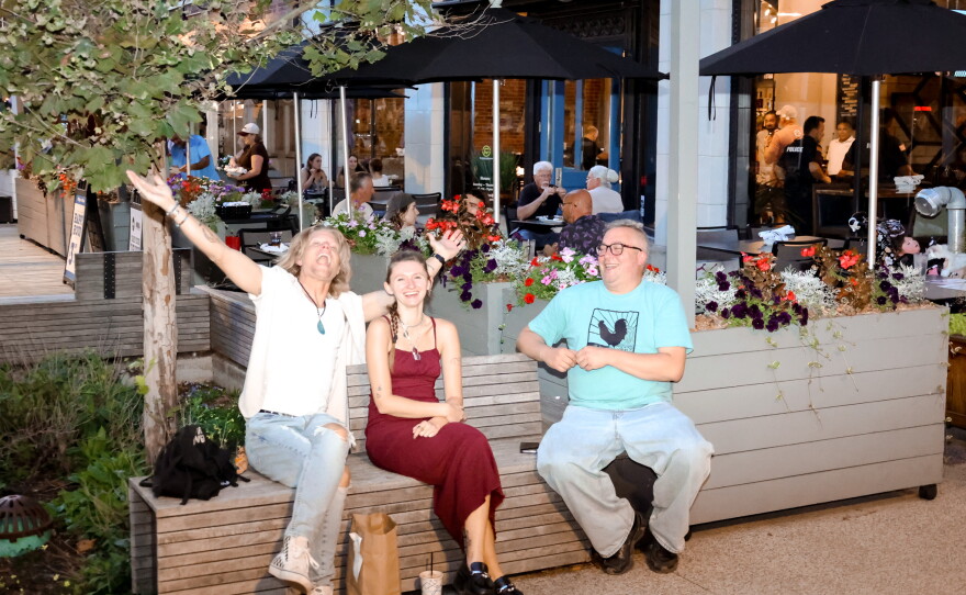 The crowd enjoys a warm evening of community and music.