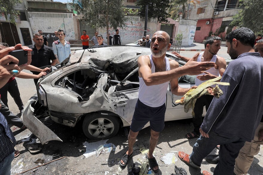 In Gaza City on Wednesday, Palestinians inspect a vehicle destroyed by an Israeli airstrike after the bodies of its passengers and driver were retrieved.