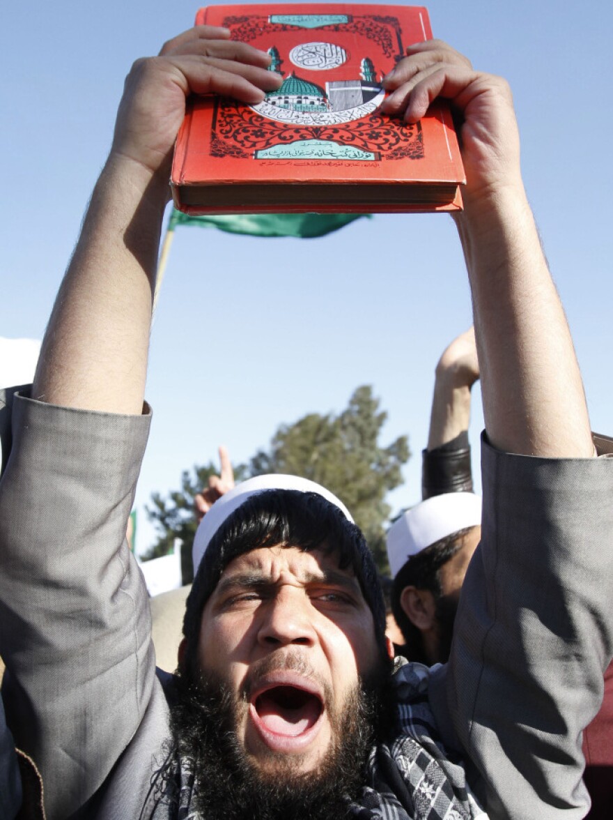 After U.S. troops burned Qurans last month, Afghans staged protests throughout the country. Here a demonstrator holds a Quran in the eastern city of Jalalabad on Feb. 22.