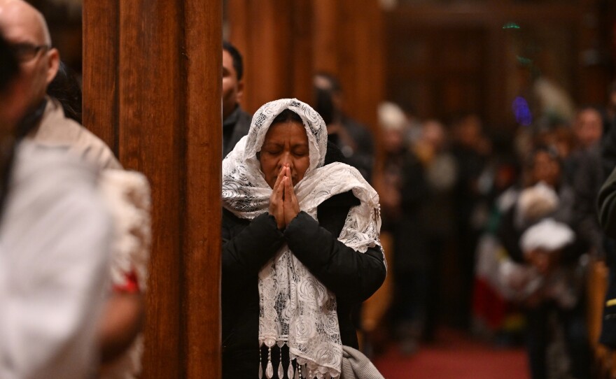 A woman prays in St. Nicholas Church on Friday, Dec. 12, in Wilkes-Barre during the Feast day of the Virgin of Guadalupe.