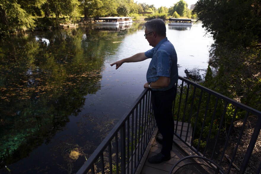 Robert Mace, executive director of the Meadows Center for Water and the Environment at Texas State University, points out features in San Marcos Springs on Thursday, in August 2023.