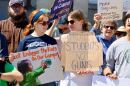Opponents of barring gun restrictions on college campuses in New Hampshire rally Tuesday before a N.H. Senate hearing on the bill