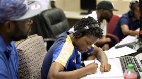 Workforce High School student Deobra Williams works with his mentor James Kern.