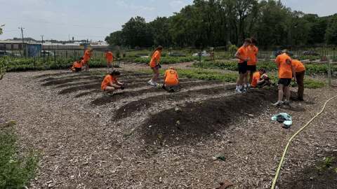 Members of Aidan's Masterpiece, a St. Joseph High School service club, volunteer to pull weeds Tuesday at Unity Gardens, 3701 Prast Blvd. in South Bend.