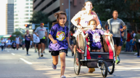 Parents run with their children during the 2024 9/11 Heroes Run.