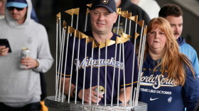 A Milwaukee Brewers fan dressed as the Commissioner's Trophy arrives for a rally during the baseball team's World Series parade, Friday, Oct. 30, 2026, in Milwaukee. (AP Photo/Nam Huh)