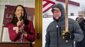 A smiling woman at a podium and a man holding a campaign sign with a snowy backdrop