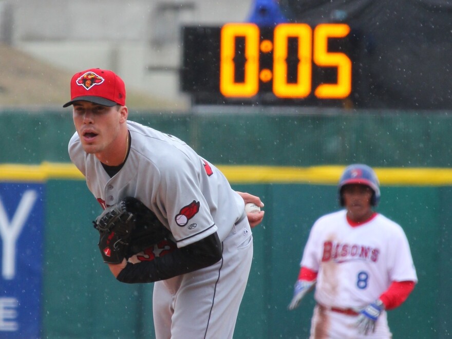 Alex Meyer, then a member of the minor-league Rochester Red Wings, watches for a signal from his catcher as a 20-second pitch clock counts down in 2015. On Wednesday, Minor League Baseball announced it will shave five seconds off that clock when there are no runners on base, among other rule changes.