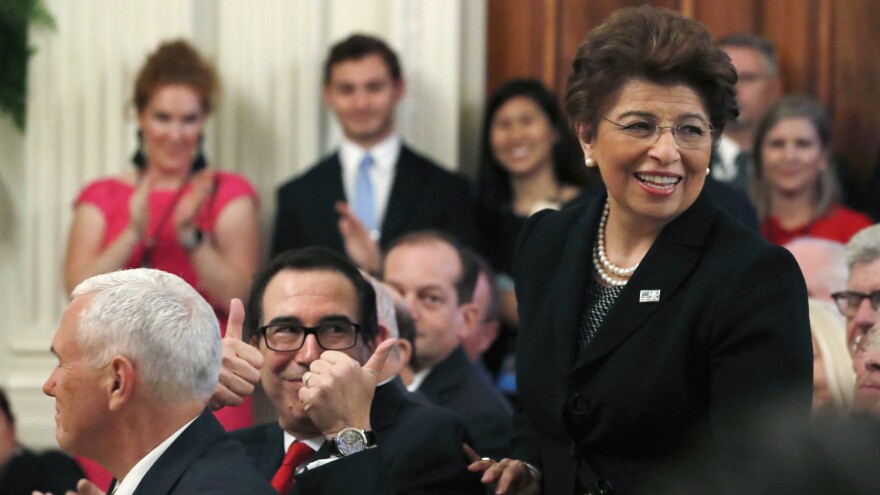 Treasury Secretary Steve Mnuchin gives two thumbs up for U.S. Treasurer Jovita Carranza in 2018. On Thursday, President Trump announced that he will nominate Carranza to lead the Small Business Administration.