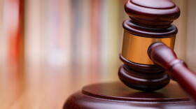 Close up Shiny Wooden Law Gavel in Dark Brown Color, on Top of Wooden Table at the Office.