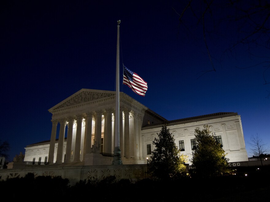 An American flag flies at half-staff in front of the U.S. Supreme Court building in honor of Supreme Court Justice Antonin Scalia.
