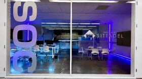 The Security Operations Center (SOC) on Florida Poly’s campus. A glass entry way with tables and chairs inside.