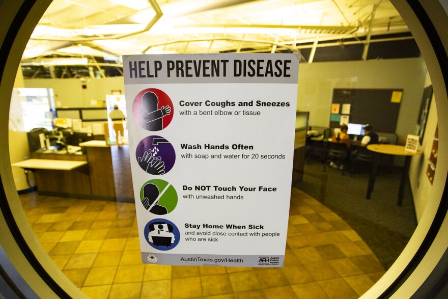 An Austin Public Health sign tells visitors how to help prevent the spread of disease. 