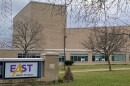 East High School is shown with the school name on a monument out front, and the building in the background.