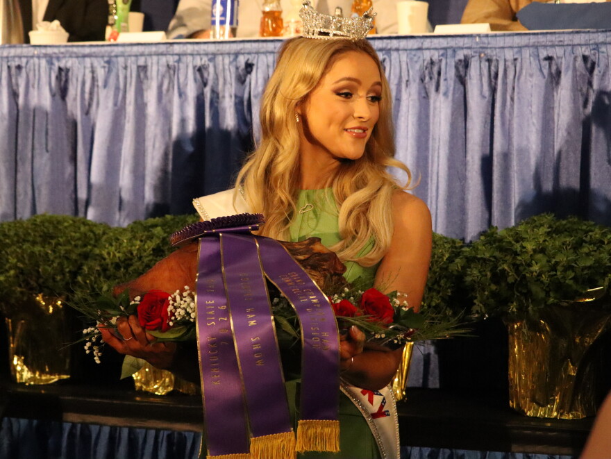 Miss Kentucky 2026 Reagan Earlywine parades around with the championship ham as bids flow in at the annual Kentucky Farm Bureau's charity ham auction.