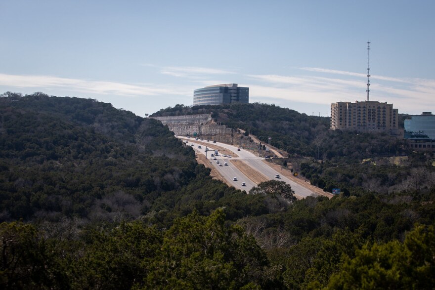 An expanse of trees separated by a highway