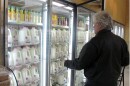A man shops for milk in a grocery store