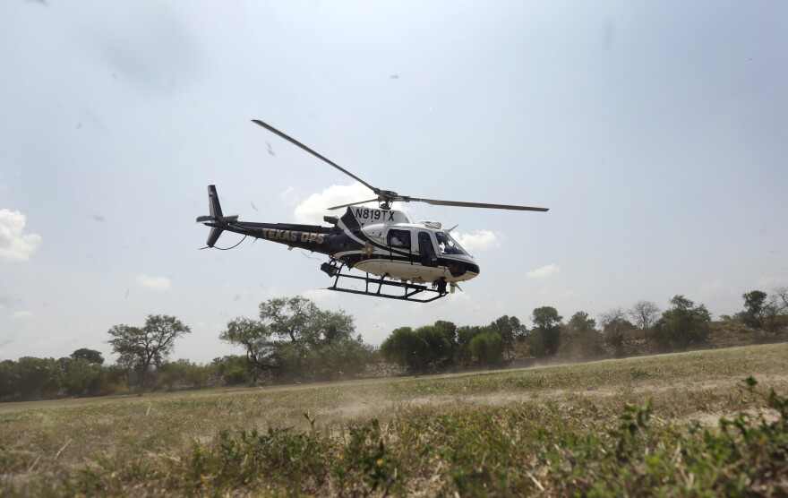 File Photo - Debris flies as a Texas Department of Public Safety helicopter takes off to patrol along the Rio Grande near Mission, Texas. REUTERS/Eric Gay/Pool (CRIME LAW MILITARY POLITICS SOCIETY IMMIGRATION)