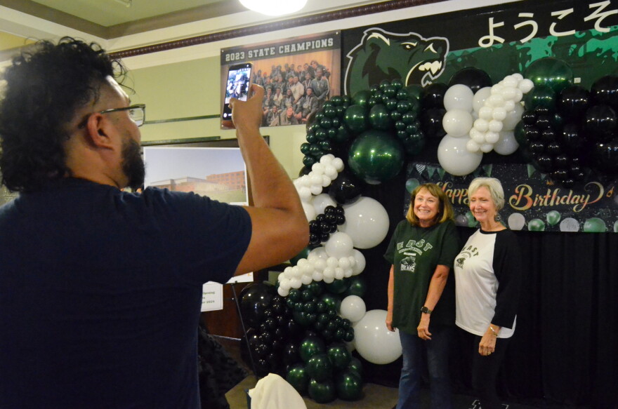 East High School alumni take photos together as they reunite to celebrate the school's centennial anniversary.