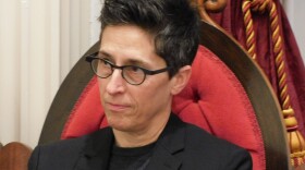Alison Bechdel listens as Clerk of the House reads proclamation naming her Vermont Cartoonist Laureate