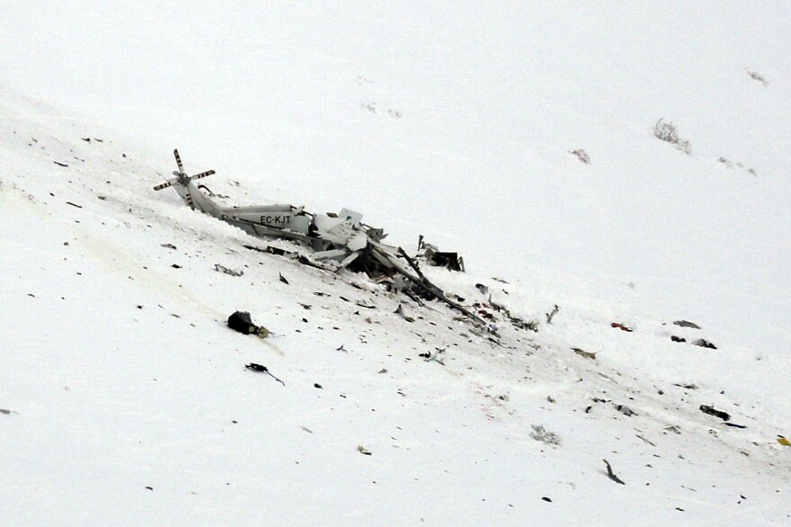 The wreckage of a helicopter lies in the snow after crashing Tuesday in the Campo Felice ski area of central Italy.