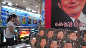 A woman walks past a display at a bookstore in Beijing.