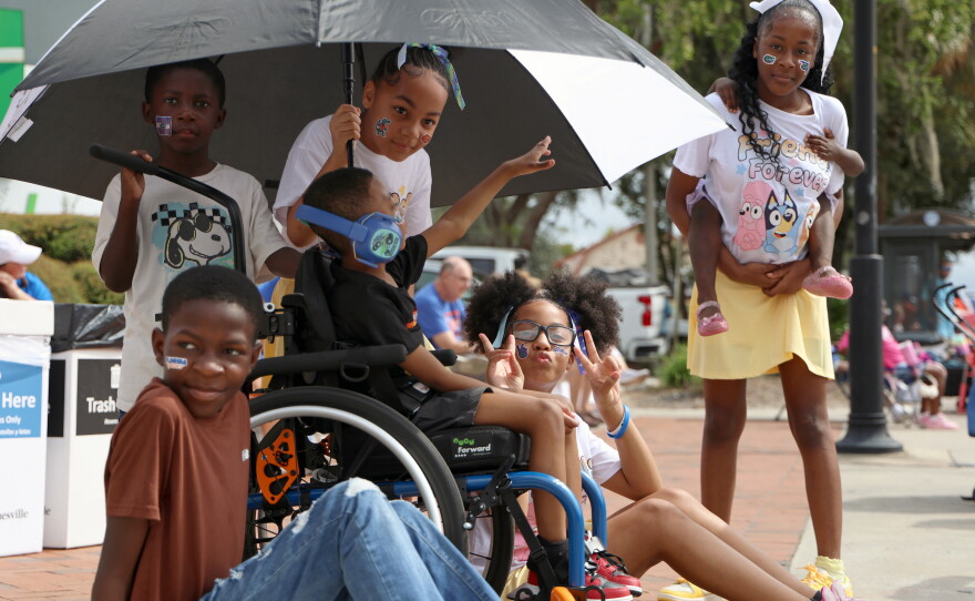 Ceonna Jones, center, poses for a photo alongside her siblings and cousins during the University of Florida Homecoming parade in Gainesville Friday, Oct. 9, 2026. (Taylin Huffman/WUFT News)