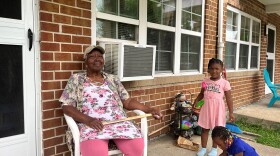 Hattie Green, 80, sits on the porch of her Calvert Square apartment with her granddaughter and great-granddaughter. Green has lived virtually all her life in different public housing complexes in Norfolk.