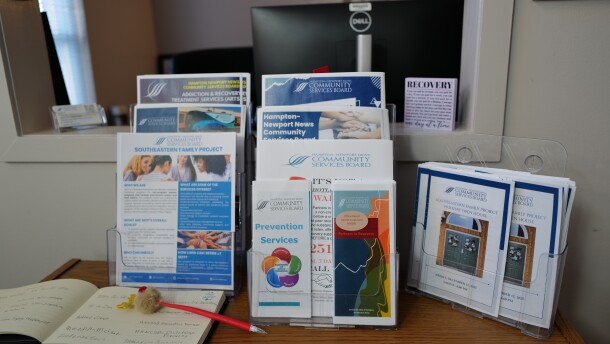 Brochures about addiction treatment and recovery services sit on display inside the South Eastern Family Project during a holiday open house on Dec. 12 in Newport News.