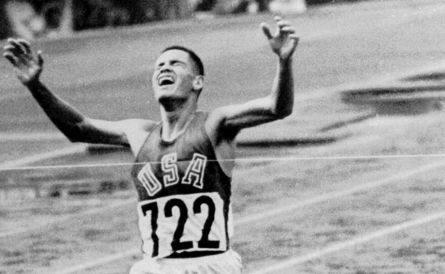 FILE - U.S. Marine Lt. Billy Mills breaks the tape to win the 10,000-meter race, setting an Olympic record, on Oct. 14, 1964, in Tokyo. (AP Photo, File)