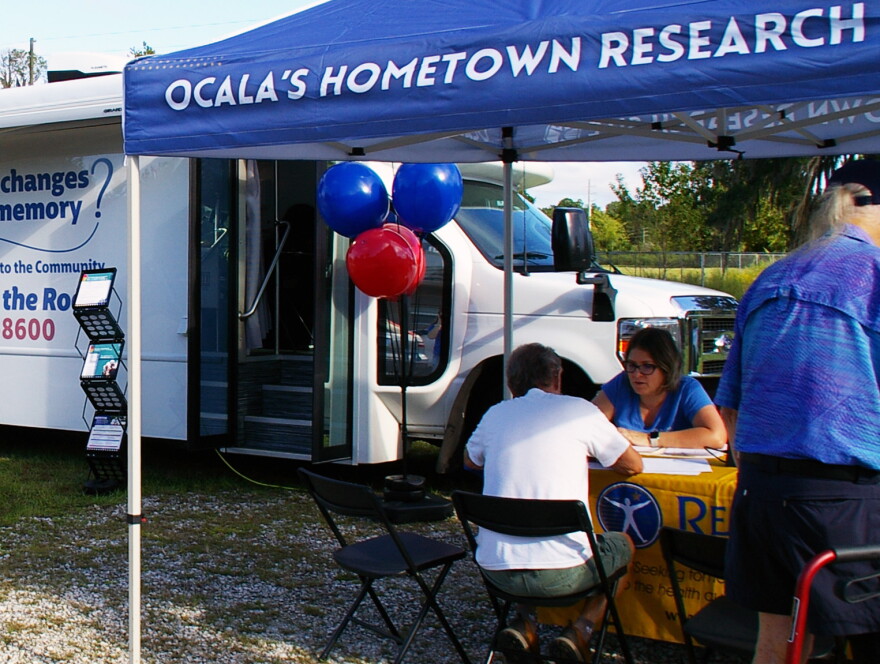 Participants speak to Renstar Medical researchers before conducting memory screenings in Dunnellon on Friday, Sept. 25, 2026. (Catherine Chapman / WUFT News)