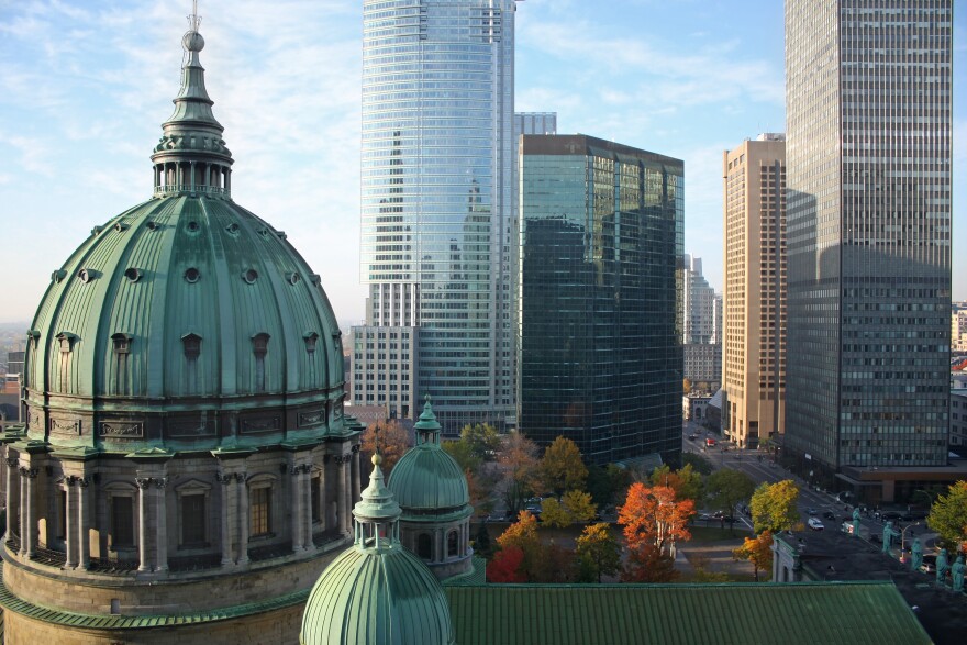 Autumn picture of the dome of the Cathedrale Marie-Reine-du-monde (Mary Queen of the World Cathedrale) and modern highrise office buildings in Montreal, Canada